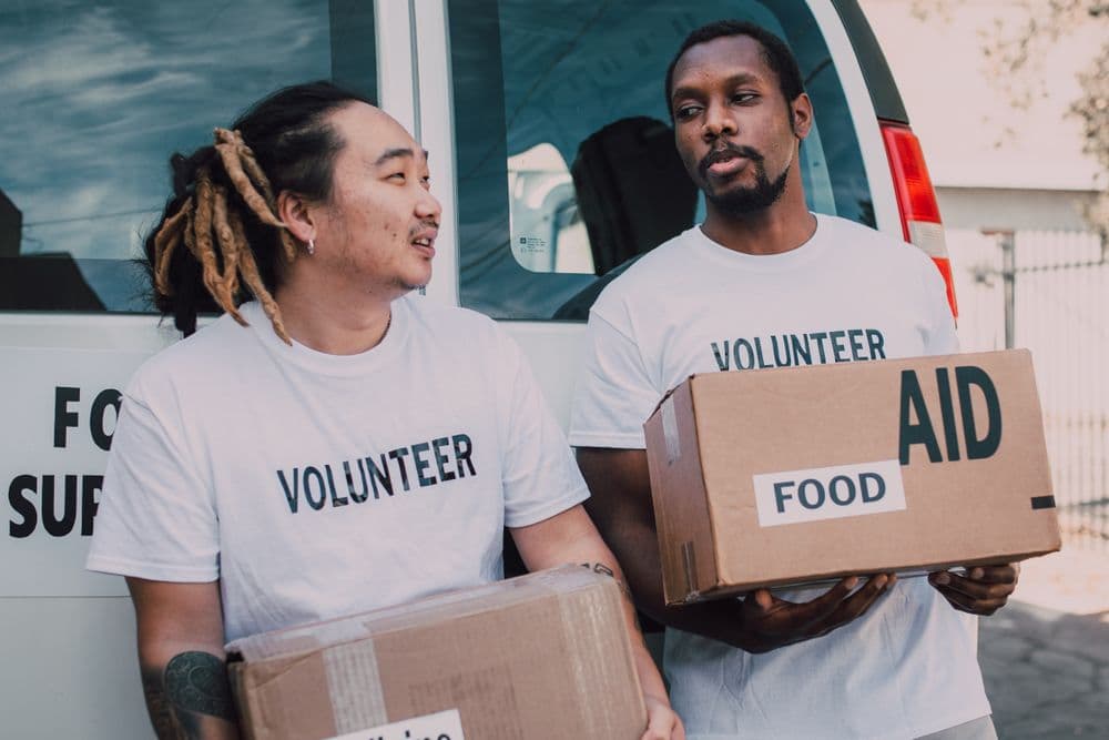 Volunteers distributing aid boxes outdoors