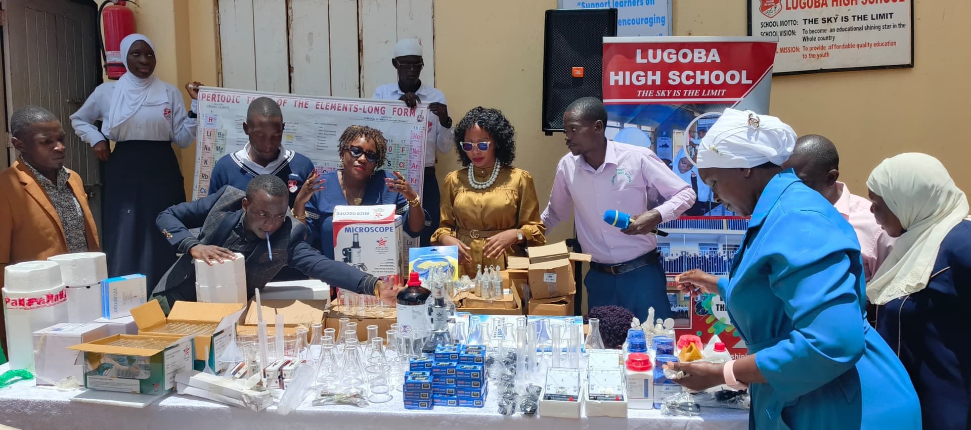 Staff and school officials with donated science lab equipment at Lugoba High School